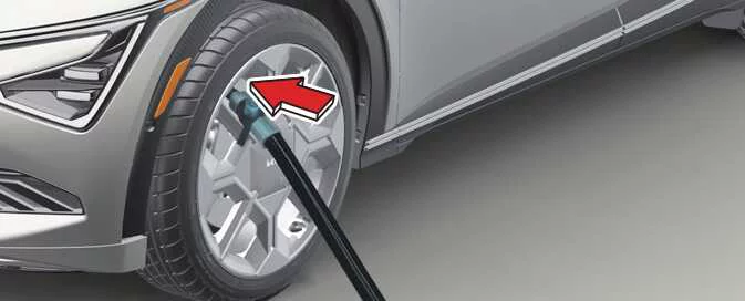 Kia EV6 checking repaired tire inflation pressure with compressor gauge